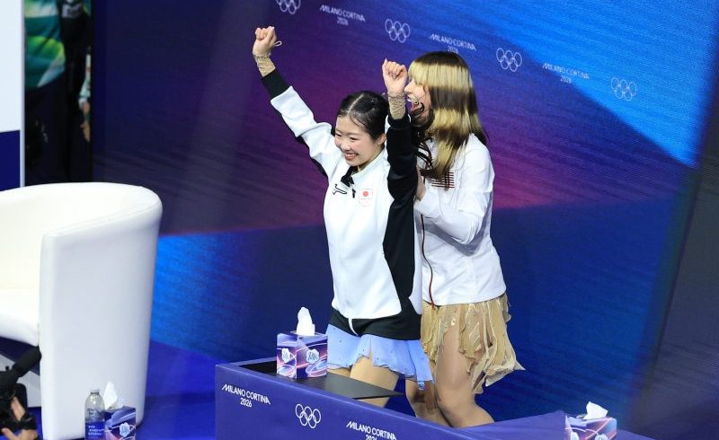 17-year-old Ami Nakai hugs Alysa Liu after both skaters medal at Olympics